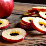 **

A close-up, vibrant shot of thinly sliced dried apple rings, some sprinkled with cinnamon, arranged artfully on a rustic wooden surface. Focus on the textures and colors.

**